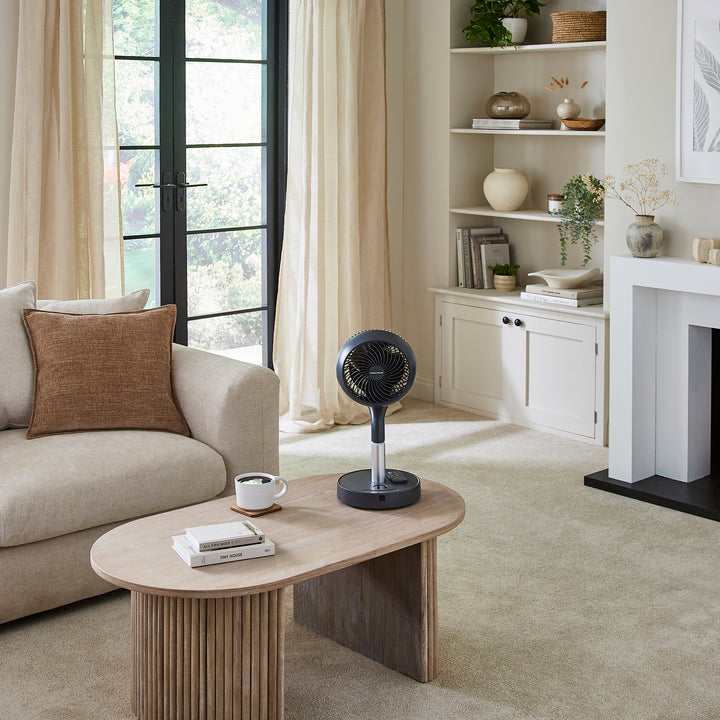 Modern living room with a coffee table, sofa, and decorative items.
