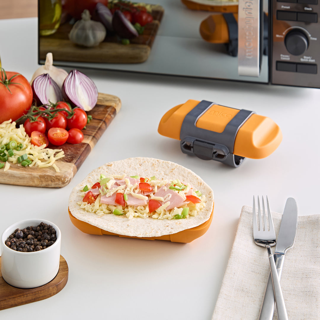 Ham and cheese wrap getting made with a wrap maker in the background 