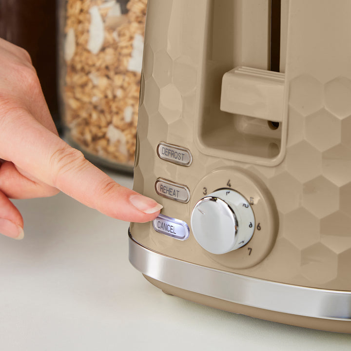 person choosing the cancel setting on a beige toaster