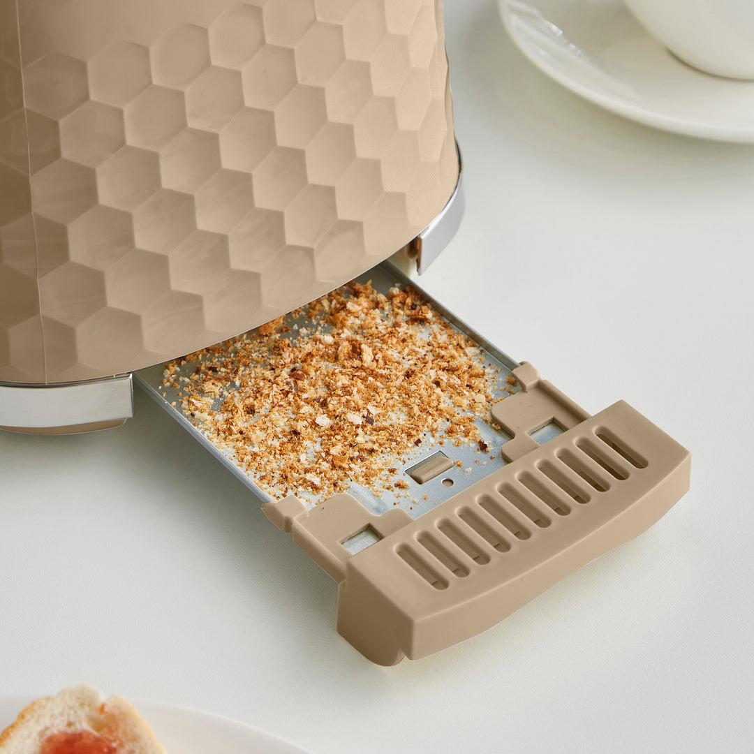 full crumb tray on a beige toaster with honeycomb design
