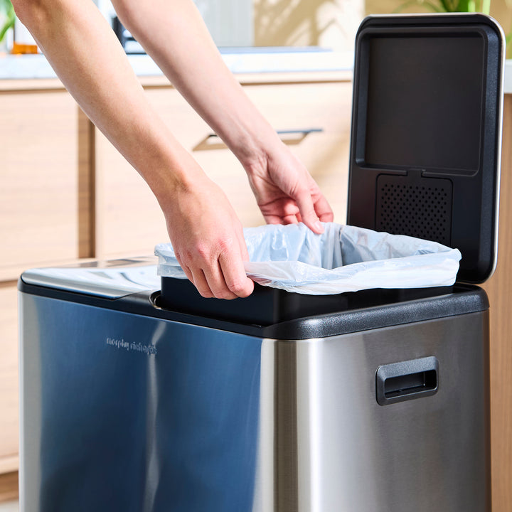 Putting a new bin bag in the bin 