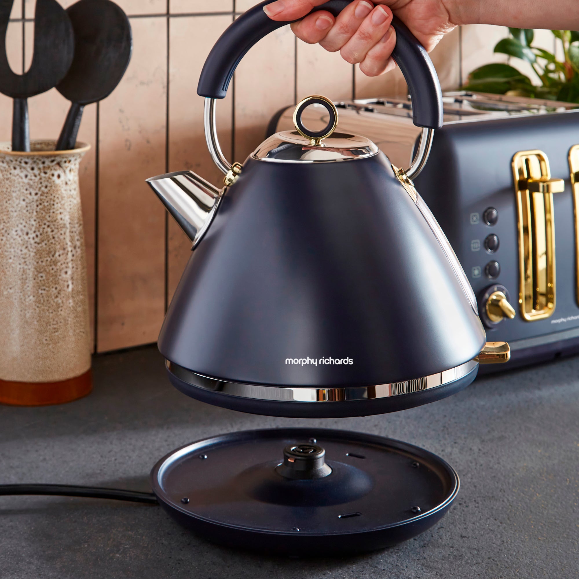 Black Morphy Richards kettle on a kitchen counter with a blurred background