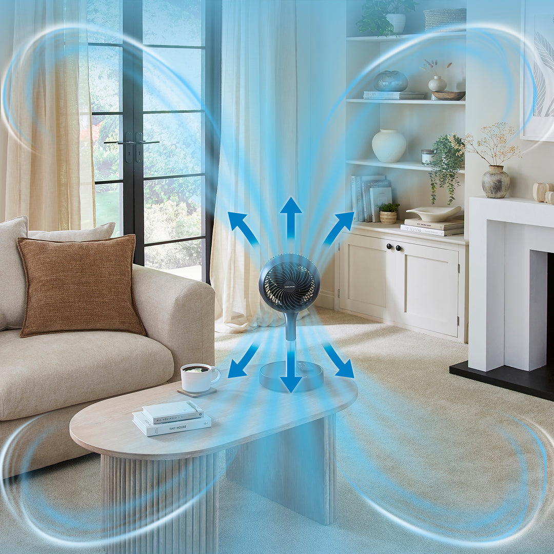 Modern living room with a fan and air circulation arrows, indicating air movement.