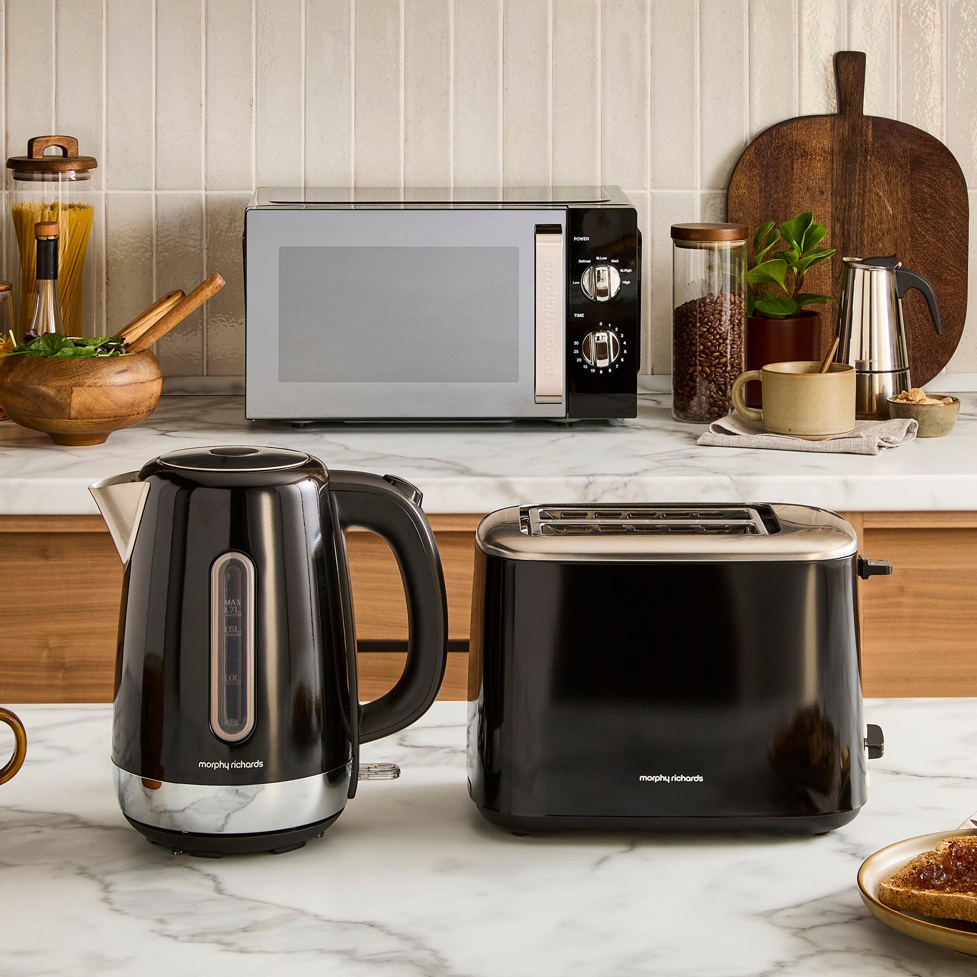 black kettle, toaster and microwave on kitchen counter