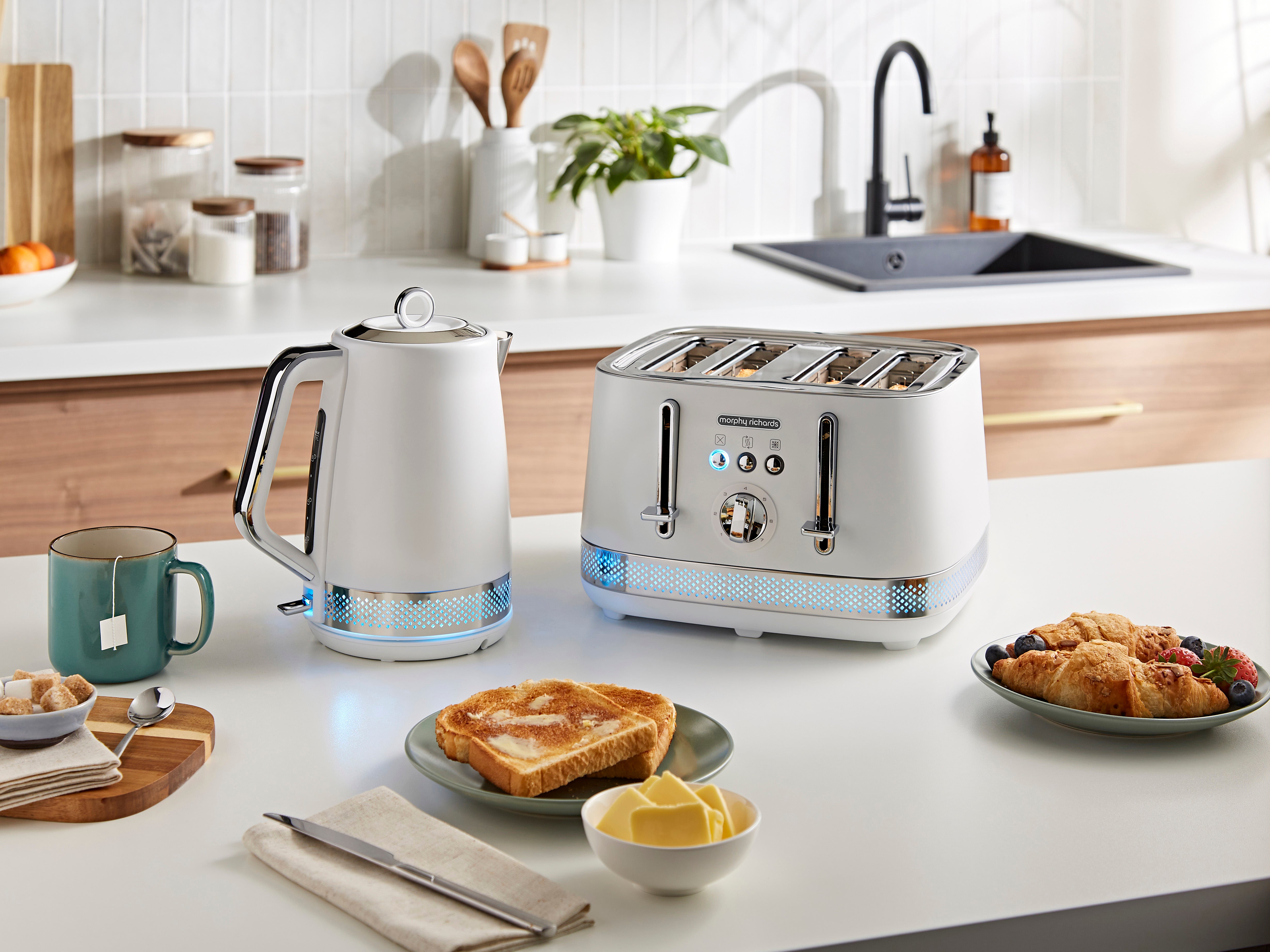 Kitchen counter with a kettle, toaster, and breakfast items in a modern kitchen.