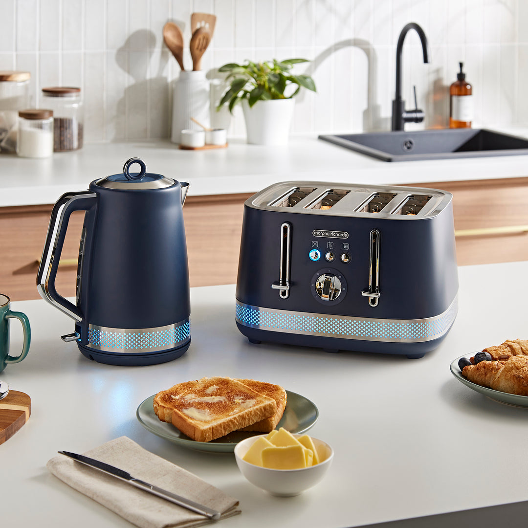 Navy blue kettle and toaster on a kitchen counter with toast and butter.