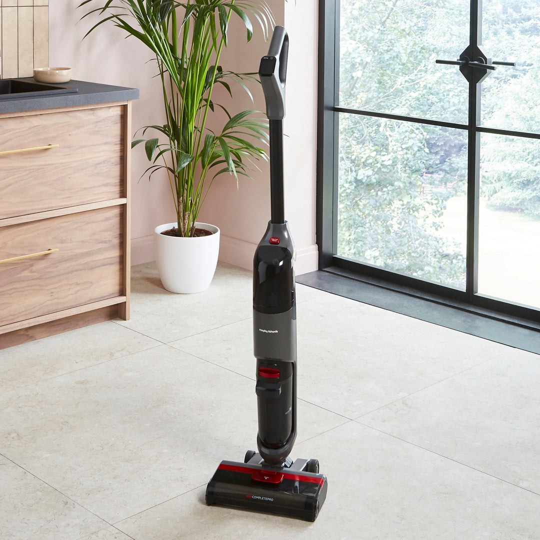 Morphy Richards floor cleaner on a tiled floor with a plant and window in the background.