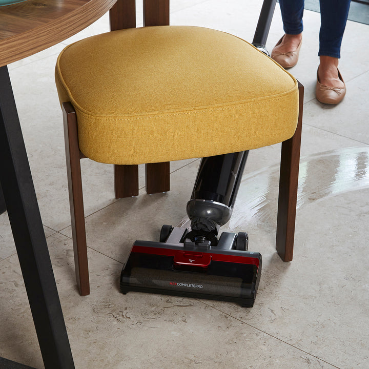 Morphy Richards floor cleaner cleaning a tiled floor next to a kitchen stool.