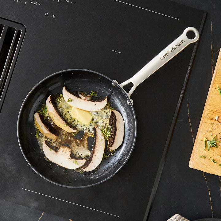 24cm Aluminium Non-Stick Frying Pan, frying mushrooms on an induction hob
