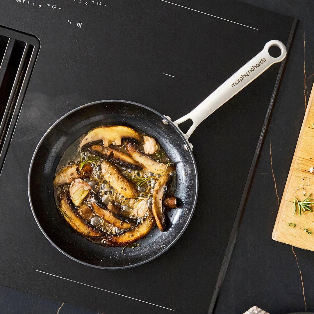 24cm Aluminium Non-Stick Frying Pan, frying mushrooms on an induction hob