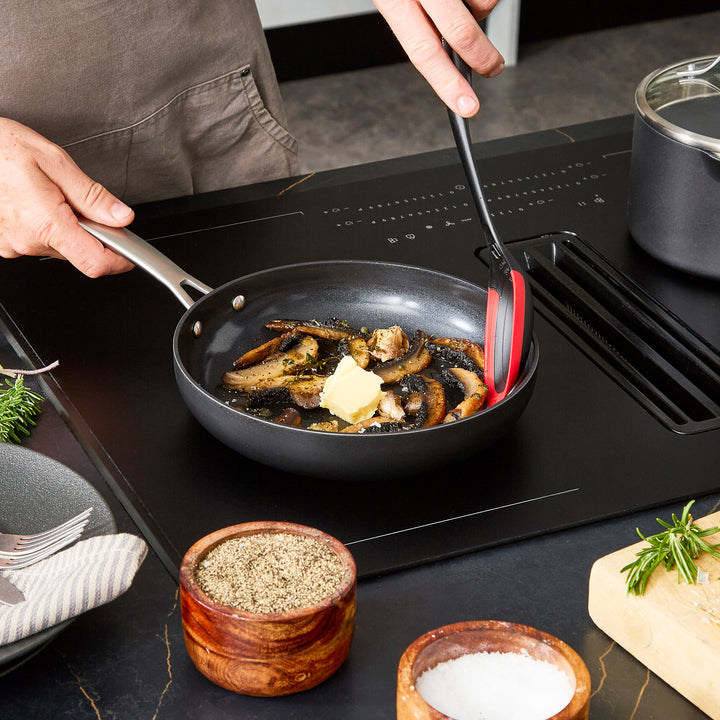 24cm Aluminium Non-Stick Frying Pan, frying mushrooms on an induction hob