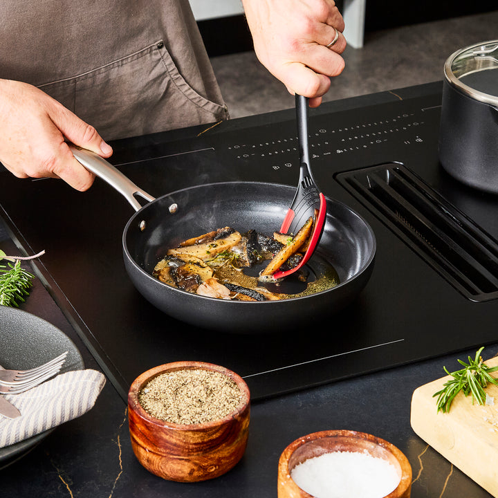 24cm Aluminium Non-Stick Frying Pan, frying mushrooms on an induction hob