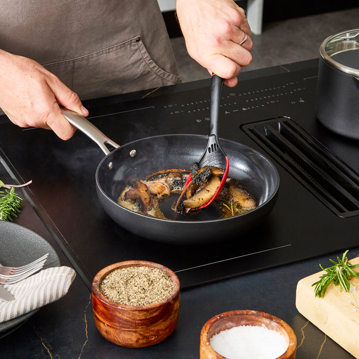 24cm Aluminium Non-Stick Frying Pan, frying mushrooms on an induction hob
