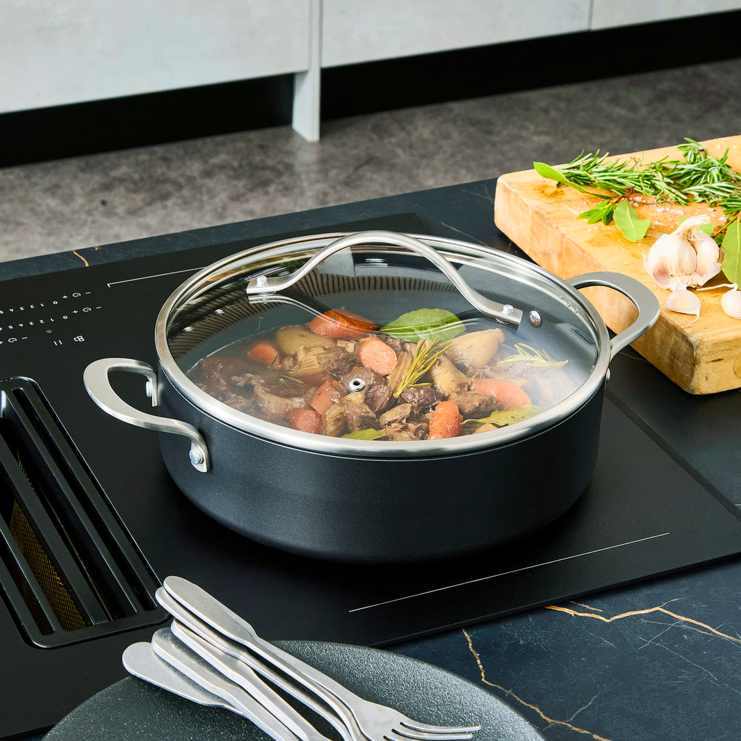 Beef stew inside the 28cm Aluminium Non-Stick Shallow Casserole Dish on an induction hob 