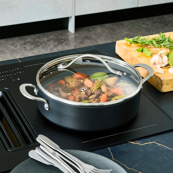 Beef stew inside the 28cm Aluminium Non-Stick Shallow Casserole Dish on an induction hob 