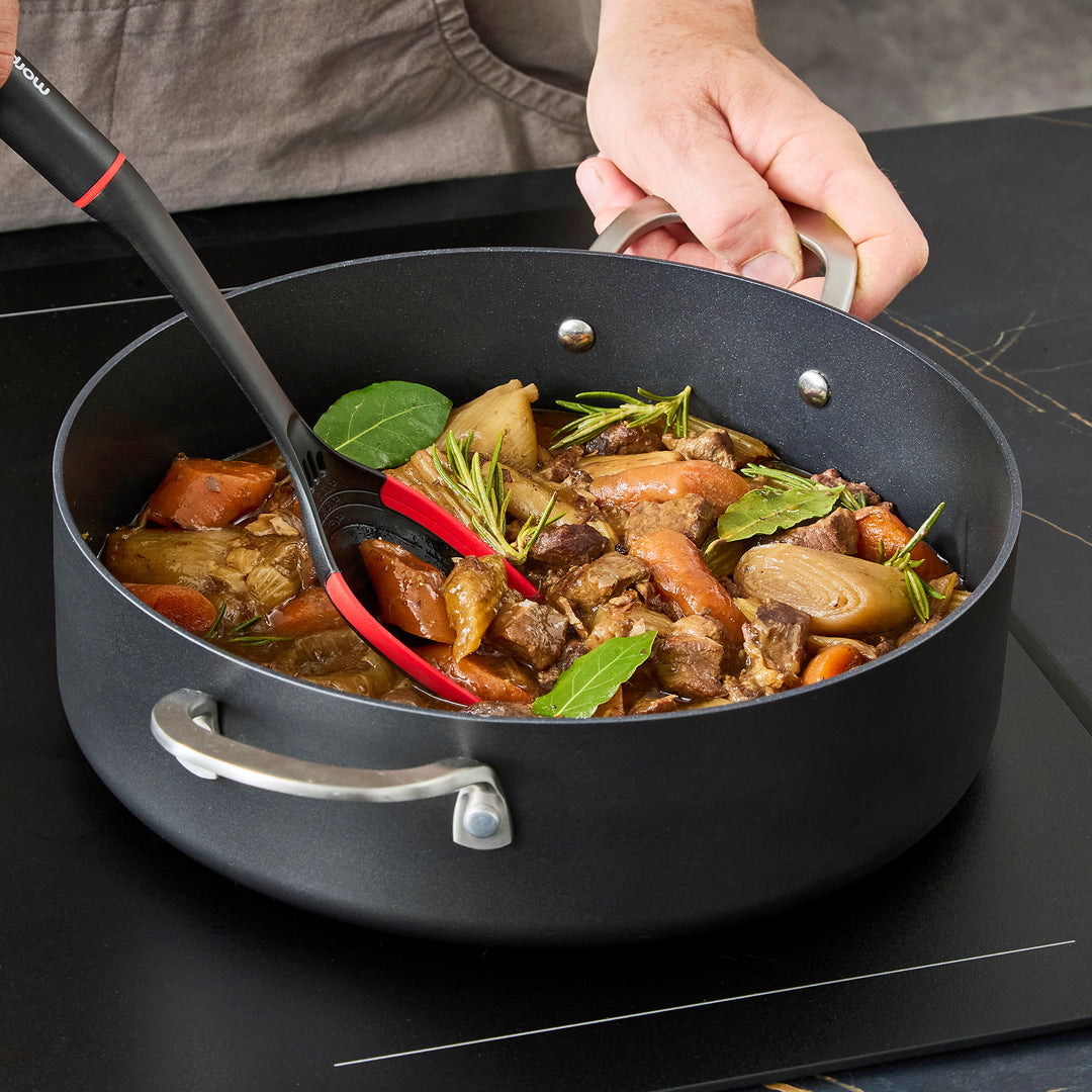 Beef stew inside the 28cm Aluminium Non-Stick Shallow Casserole Dish on an induction hob 
