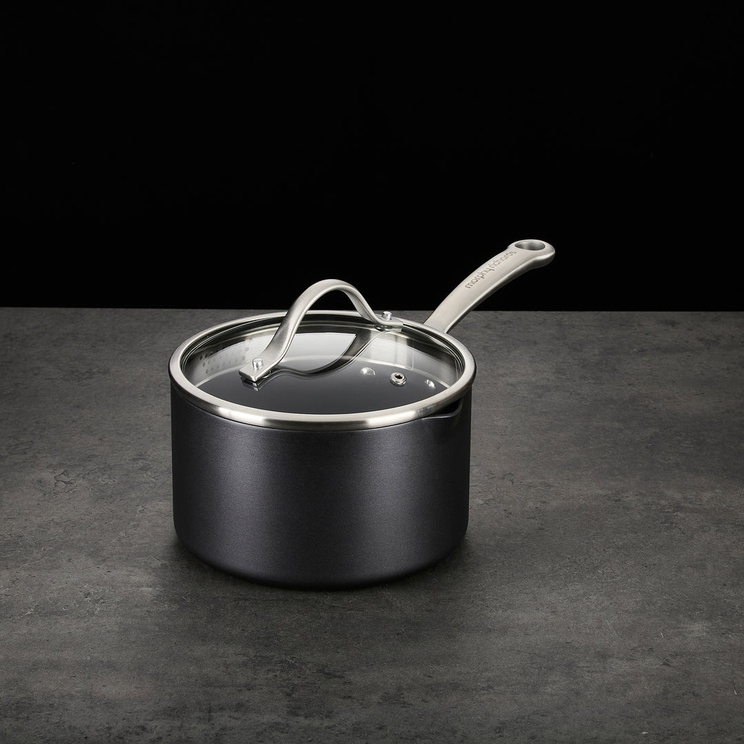 Saucepan with lid on granite countertop 