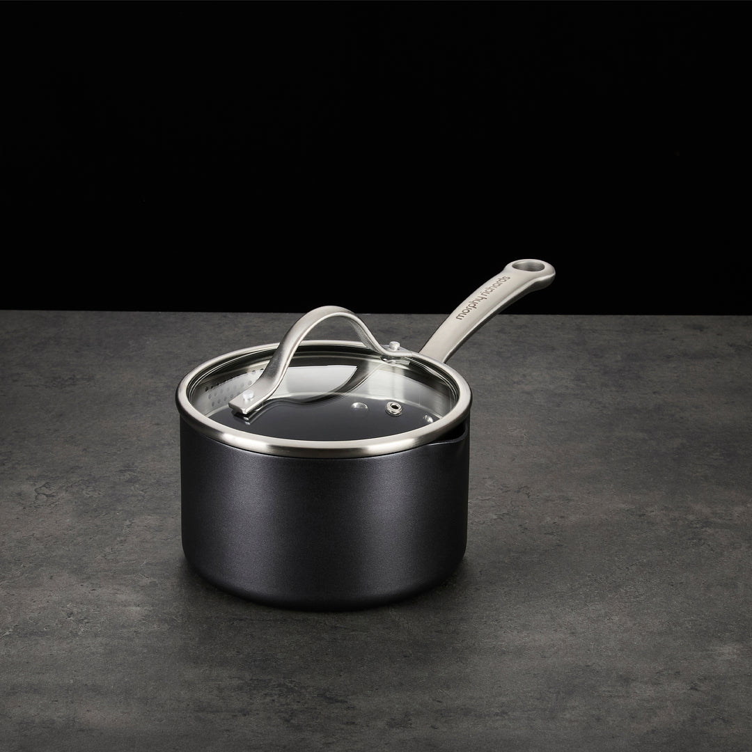 Saucepan with lid on granite countertop 