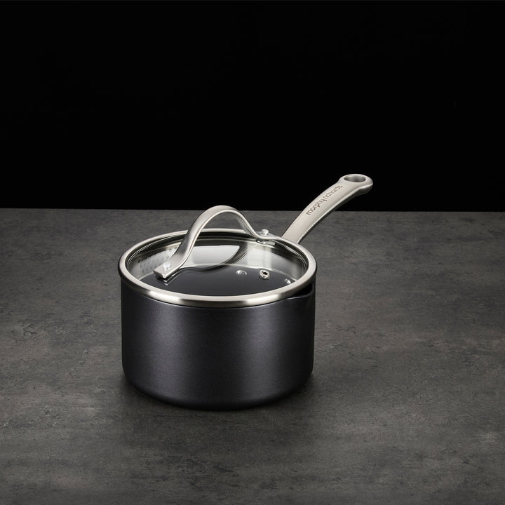 Saucepan with lid on granite countertop 
