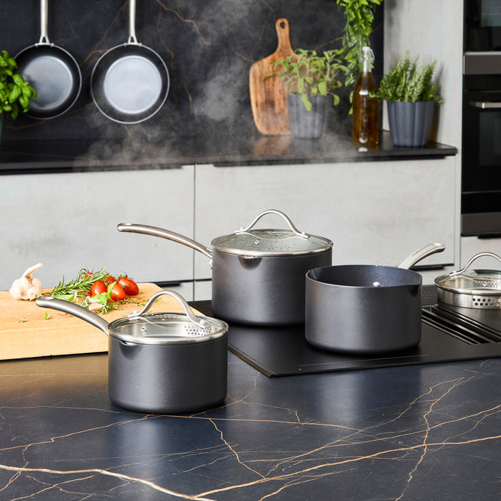 3 Piece Aluminium Non-Stick Pan Set on a granite countertop 