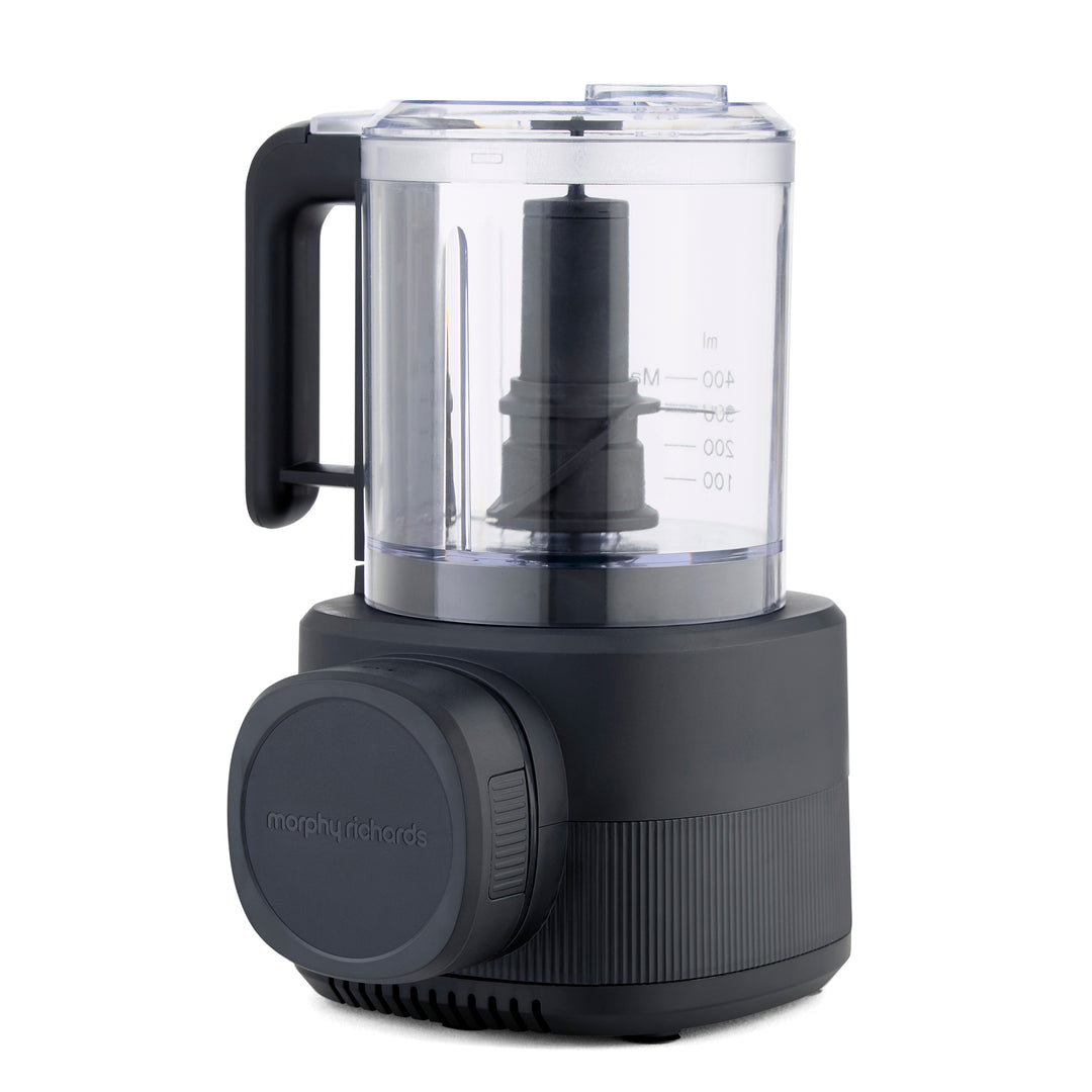 A countertop food processor with a clear plastic bowl
