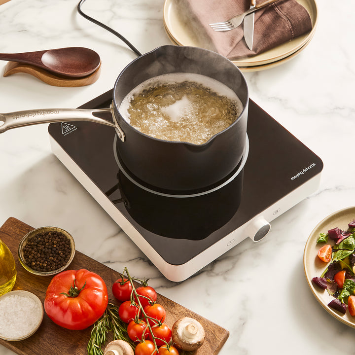 single induction hob with pan placed on top in a kitchen setting